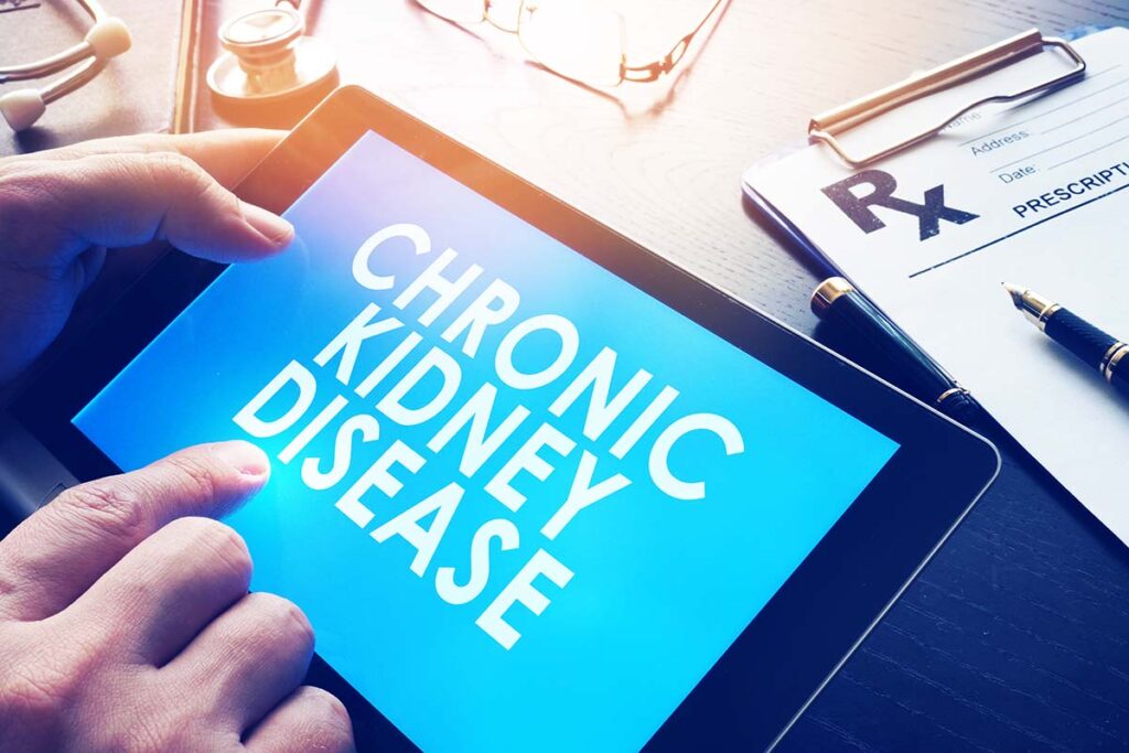 Hands holding tablet that says chronic kidney disease