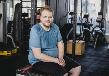 overweight man at the gym, where he might experience fatphobia