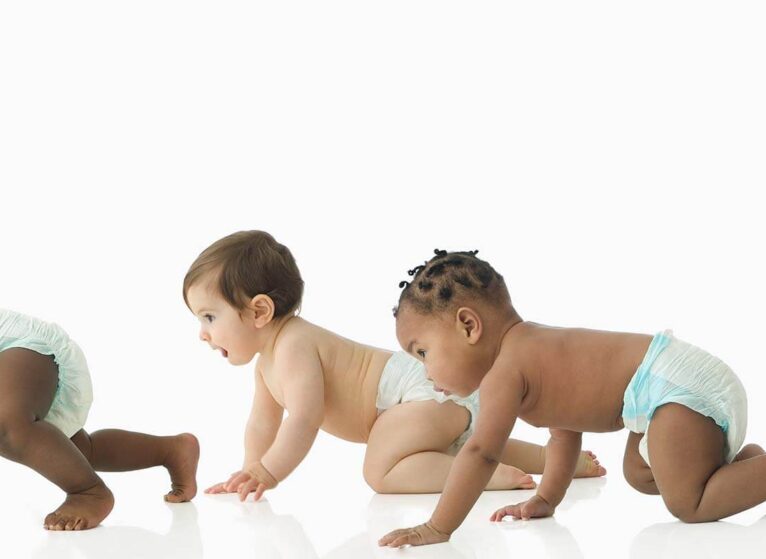 Babies crawling in a baby race