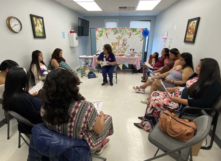Women sitting in a circle at a baby shower