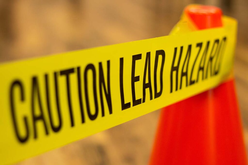 Sign that says caution lead hazard