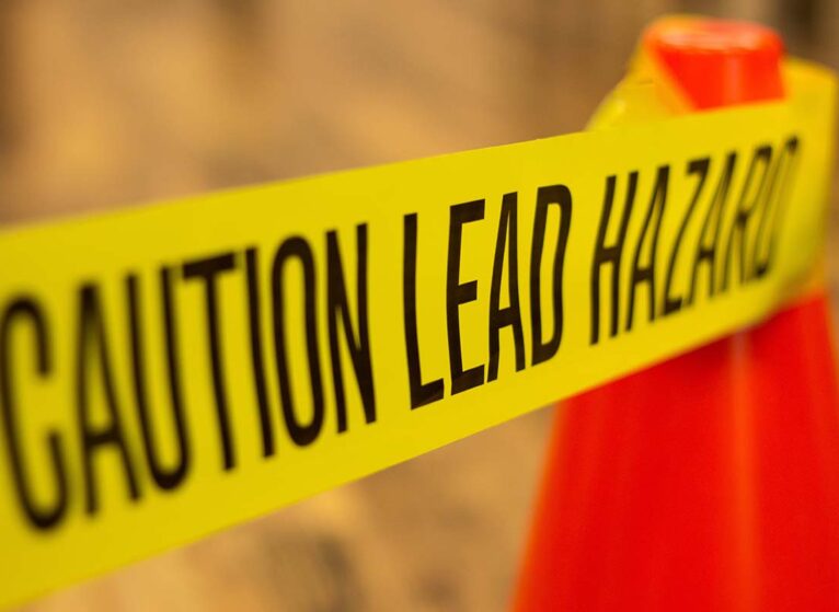 Sign that says caution lead hazard