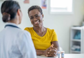 Black woman meeting with a healthcare provider