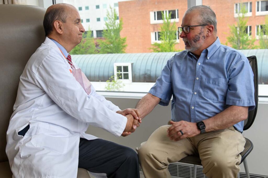 Camilo Fadul, MD, left, talks with David Lunt at a recent appointment.