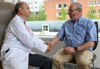 Camilo Fadul, MD, left, talks with David Lunt at a recent appointment.