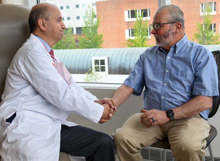 Camilo Fadul, MD, left, talks with David Lunt at a recent appointment.