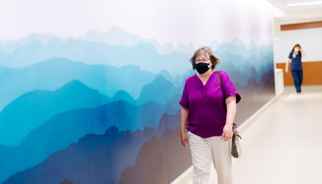 Ann Woodward, a stage 4 cancer survivor, walks through UVA Health's Cancer Center