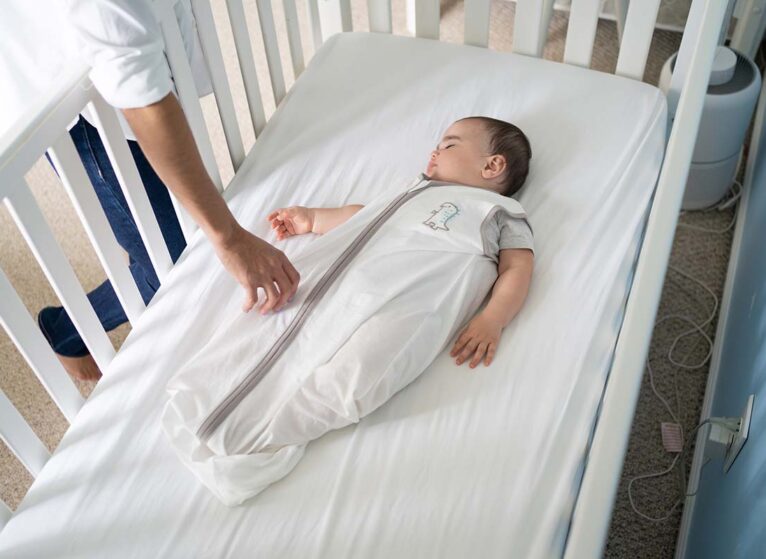 Baby sleeping in sleep sack safely