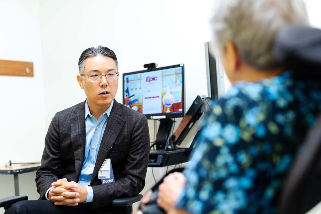 Dr. Robert Shin talks with a patient