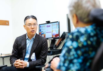 Dr. Robert Shin talks with a patient