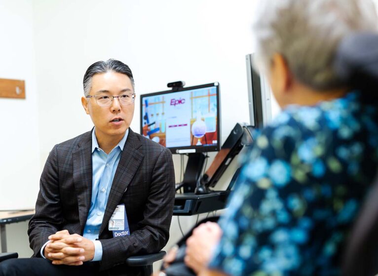 Dr. Robert Shin talks with a patient