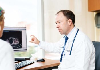 Ryan Gentzler, MD, talks with a patient