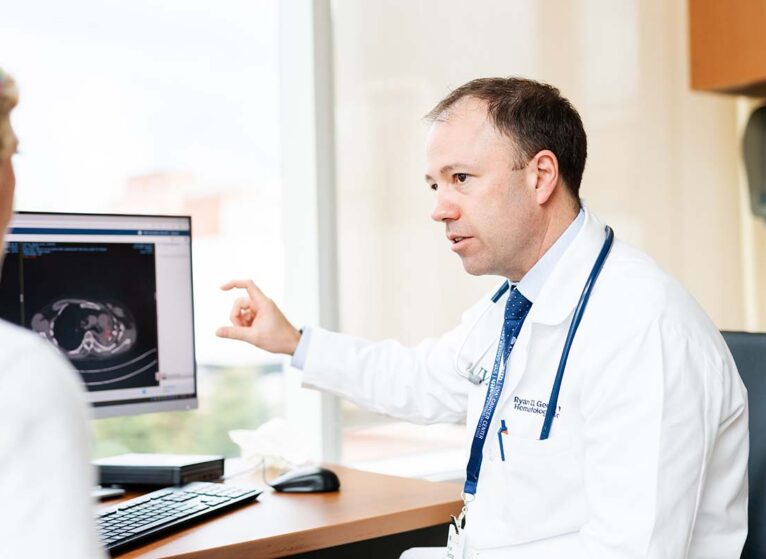 Ryan Gentzler, MD, talks with a patient