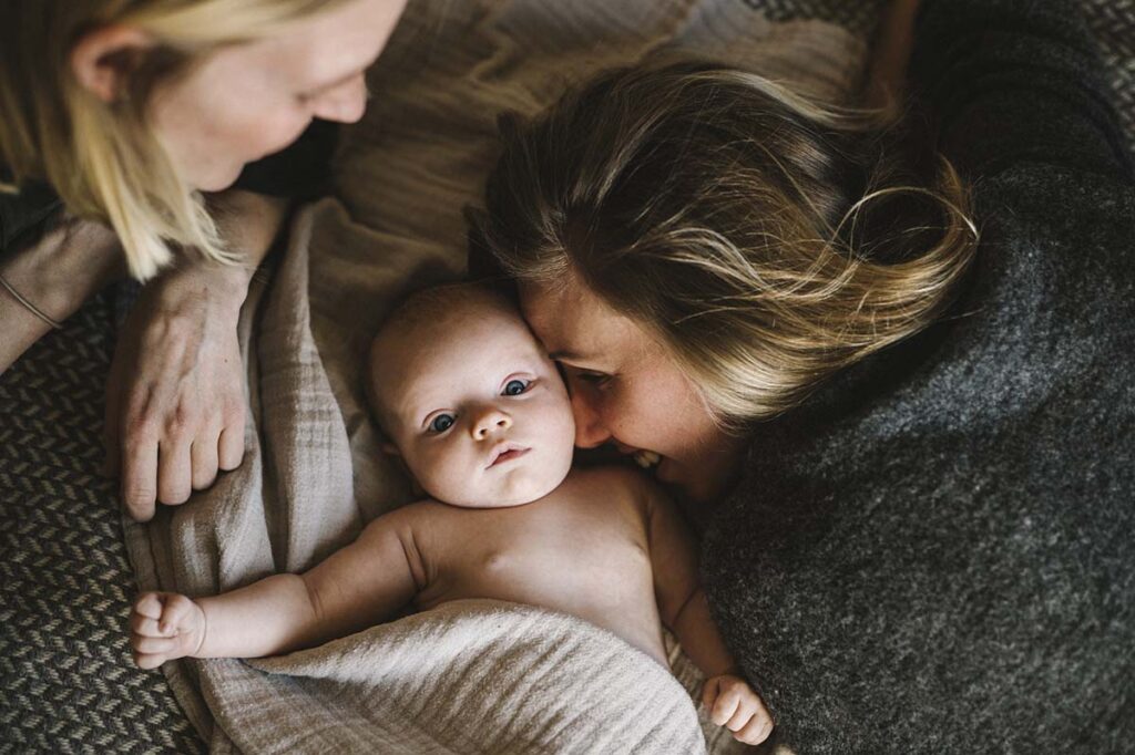 Moms in bed with newborn baby