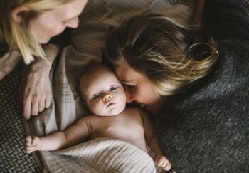 Moms in bed with newborn baby