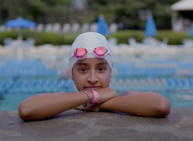 Girl with swim cap and goggles