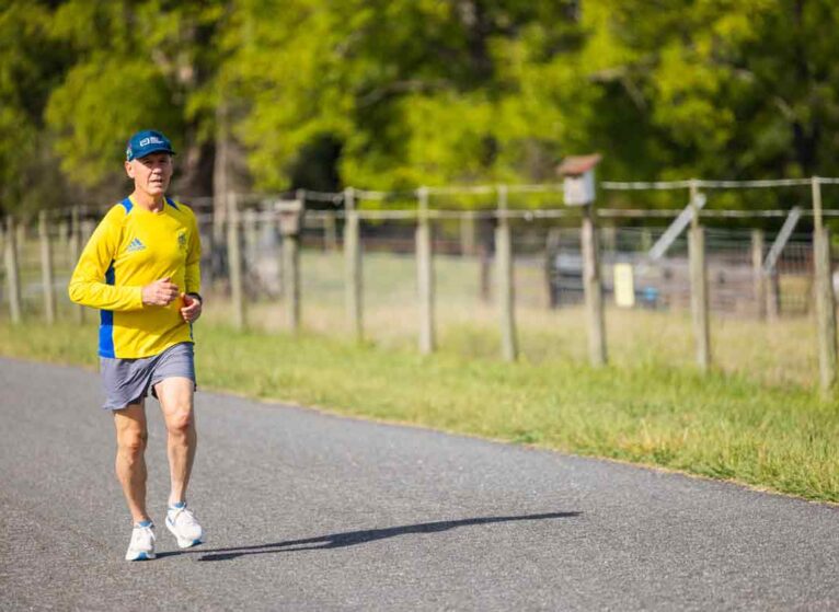 Harry Landers running on a road in the Virginia countryside