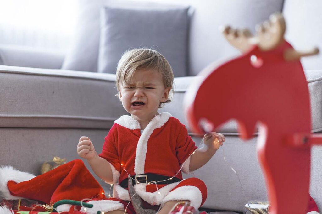 Child in santa suit having meltdown