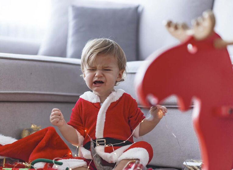 Child in santa suit having meltdown