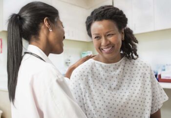 Doctor comforting patient in office