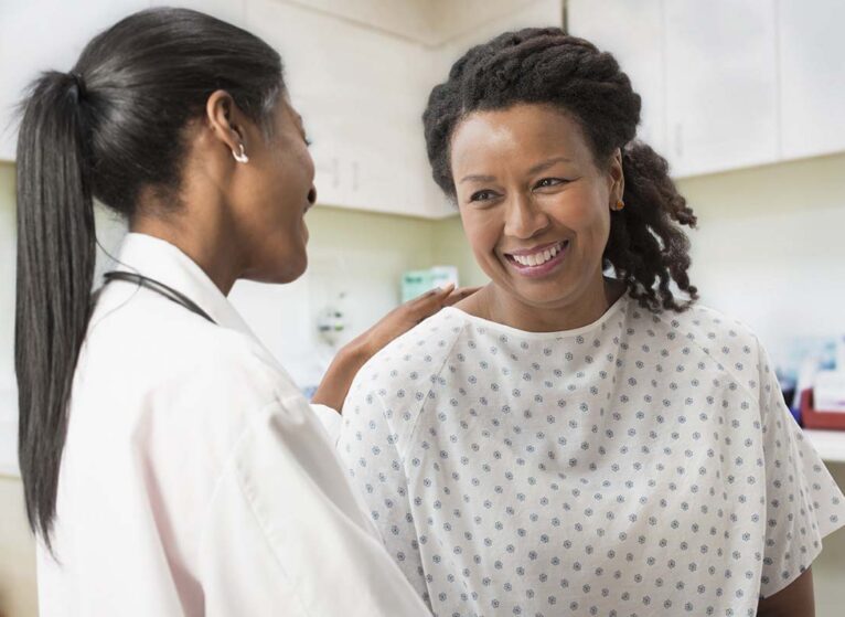 Doctor comforting patient in office