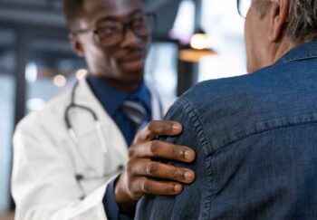 A doctor touching the arm of a sarcoma patient