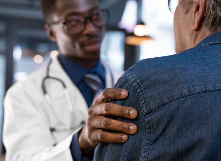 A doctor touching the arm of a sarcoma patient