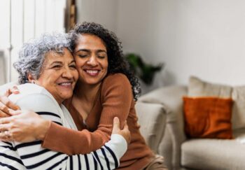 And older and younger woman hug