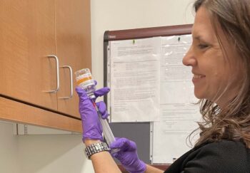 A pharmacist draws up an injection