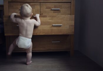 Baby looks in drawer